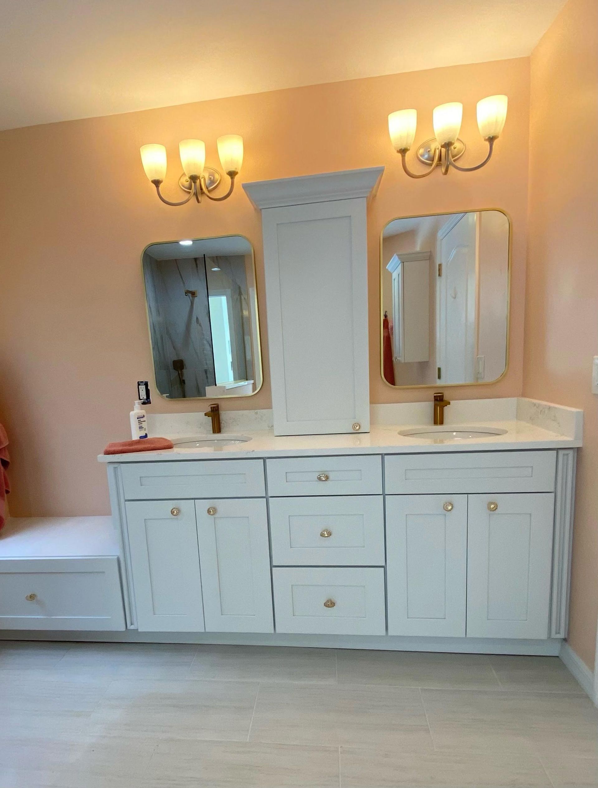 A bathroom with two sinks and two mirrors