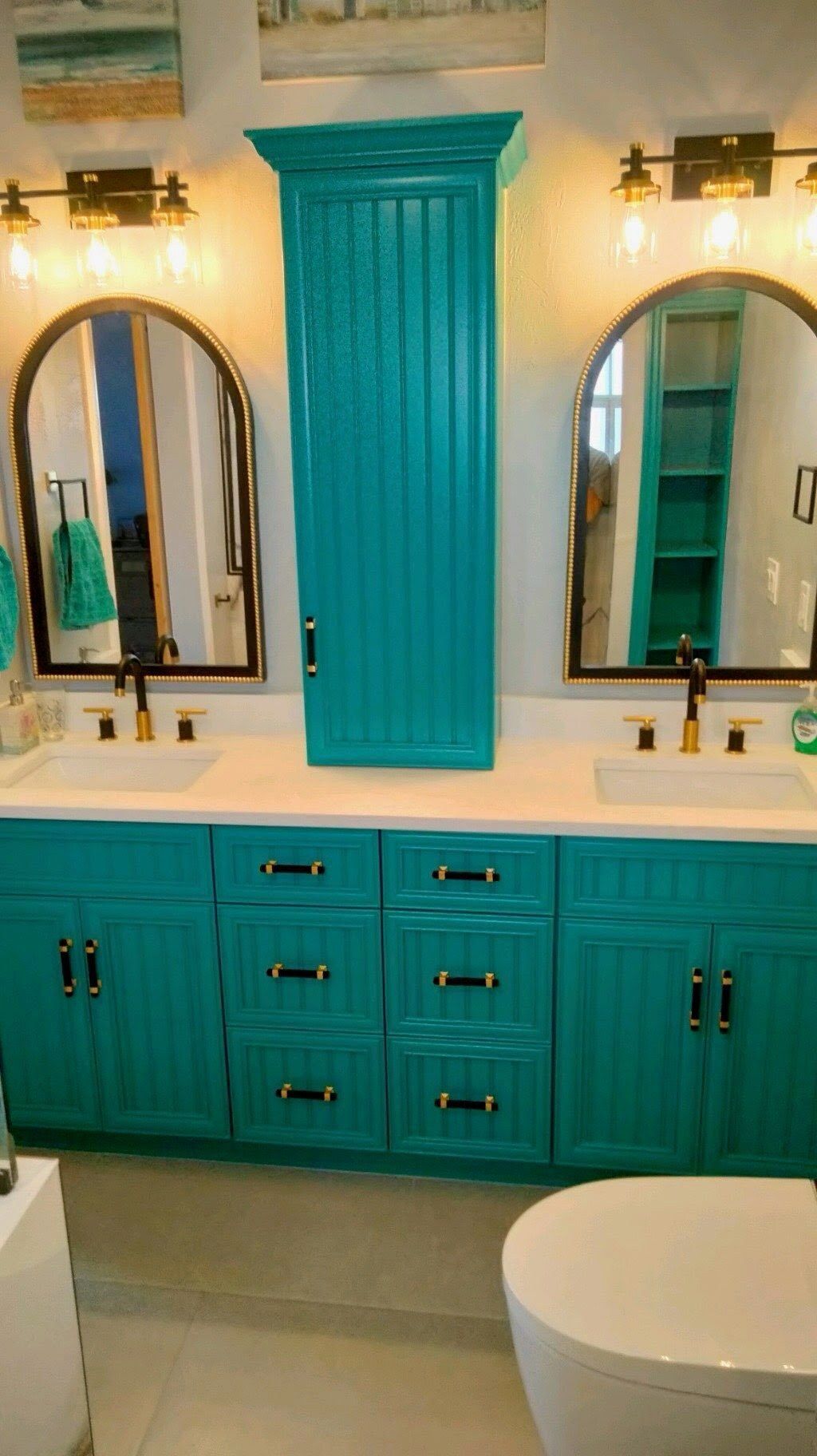 A bathroom with two sinks , two mirrors , a toilet and a bathtub.