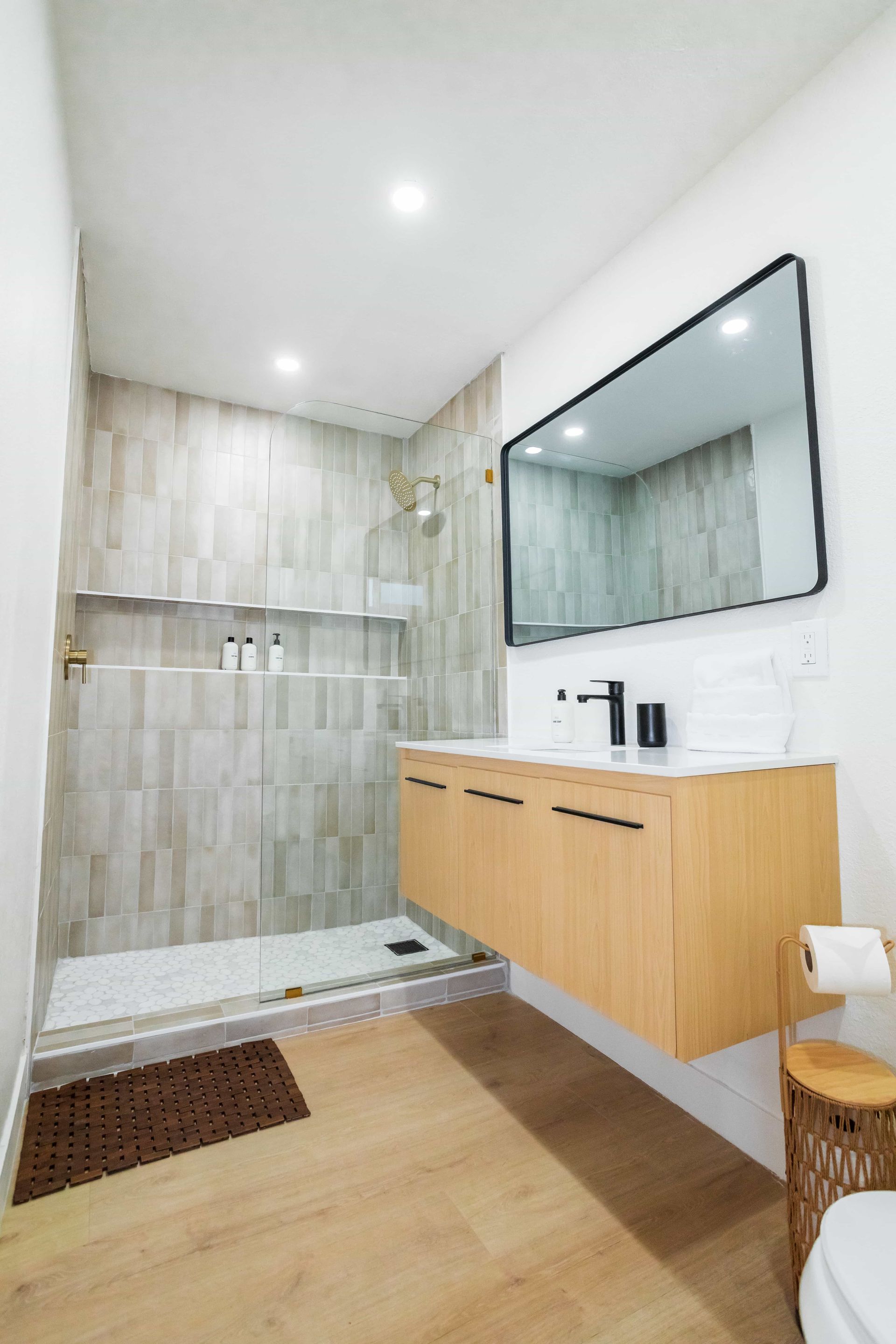 A bathroom with a sink , toilet and shower.
