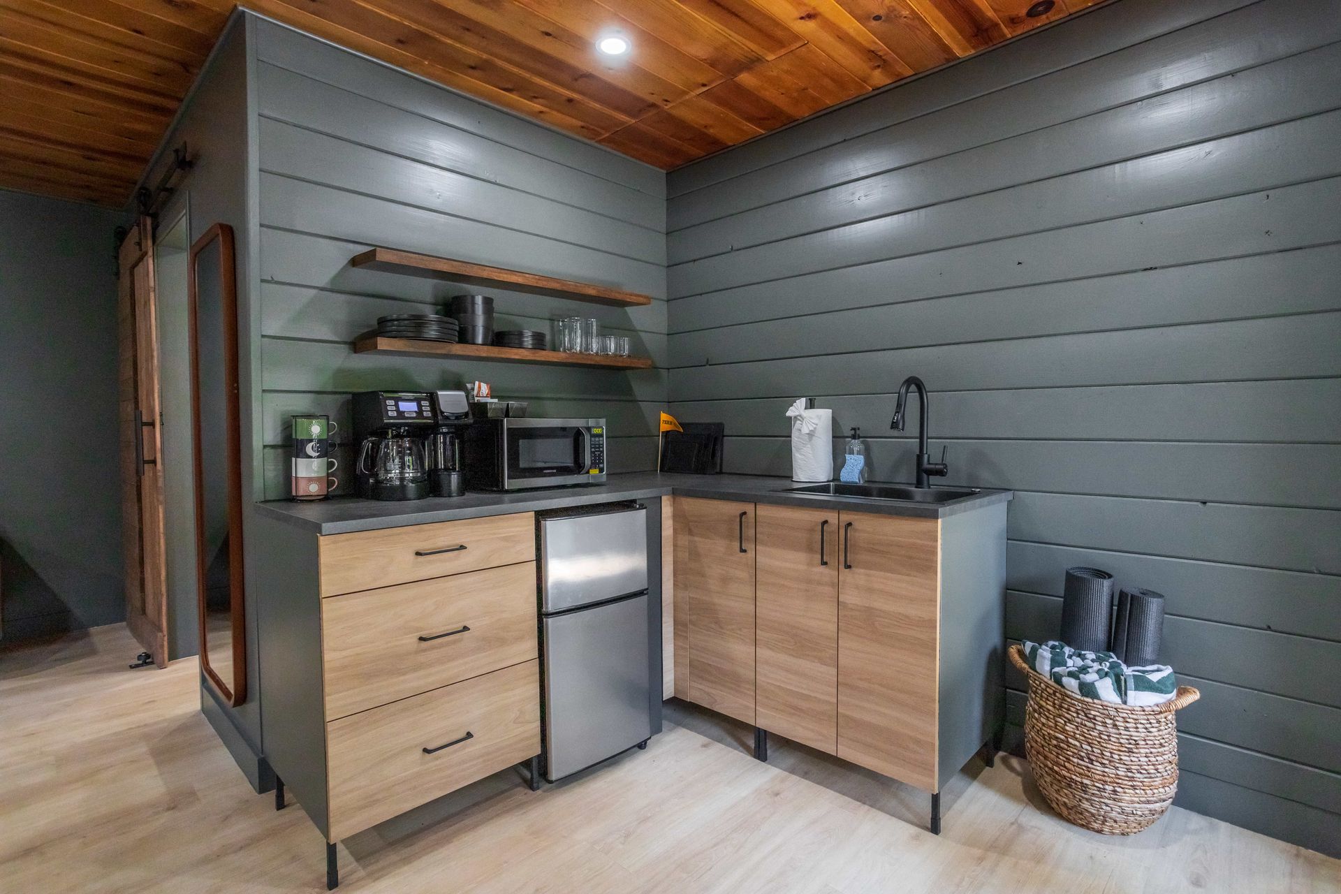 A kitchen with stainless steel appliances and wooden cabinets.