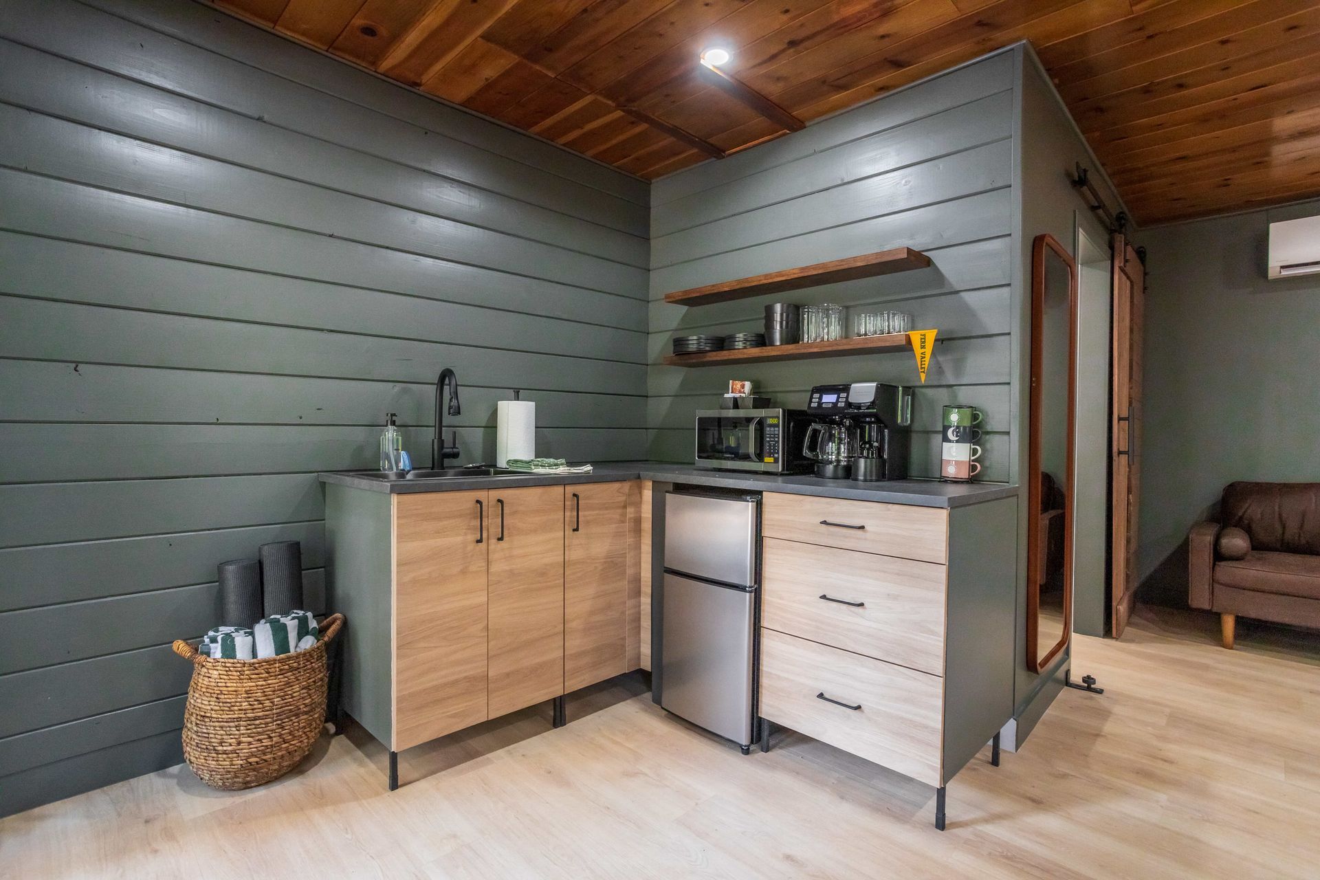 A kitchen with stainless steel appliances and wooden cabinets.