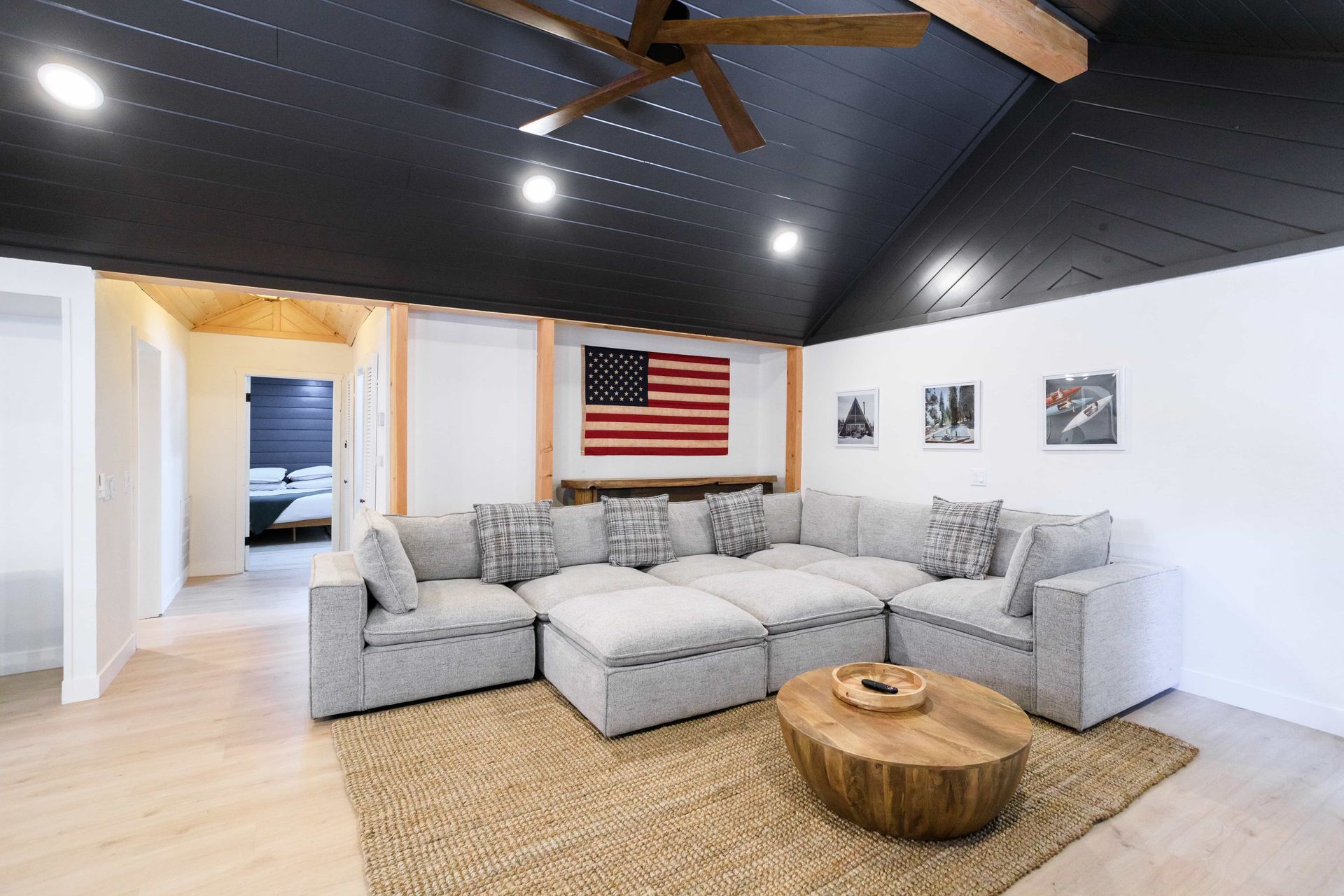 A living room with a large sectional couch and a coffee table.