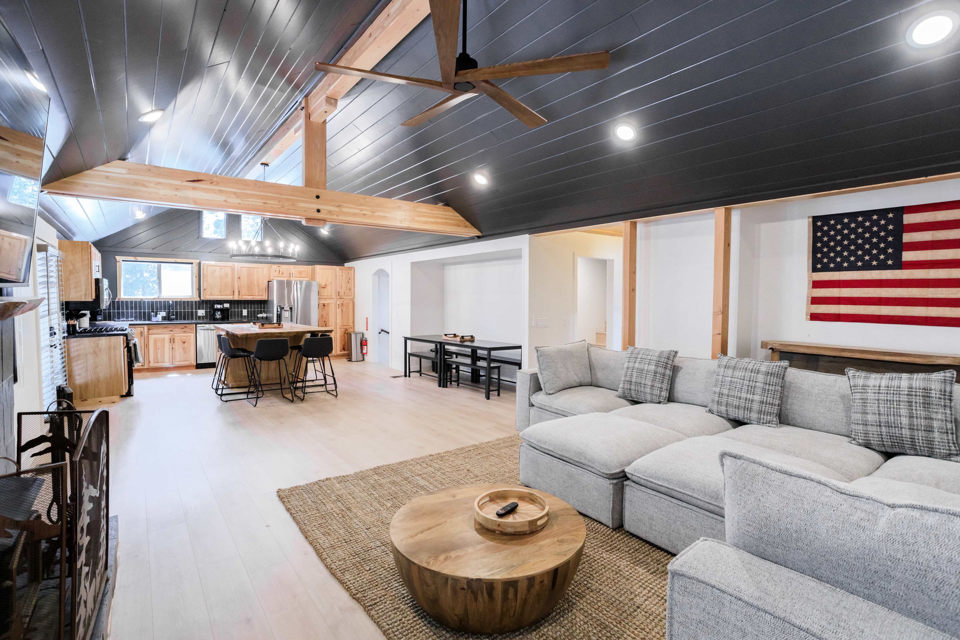 A living room with a large american flag on the wall.