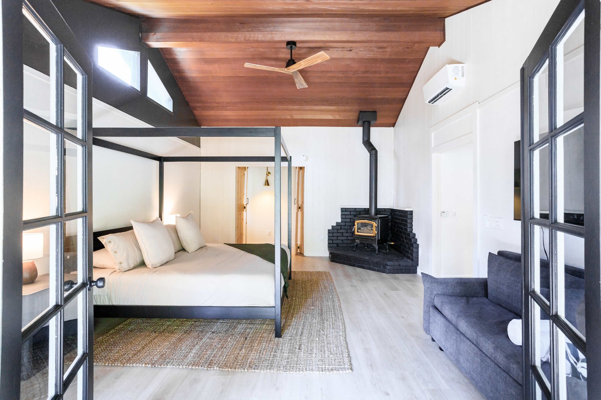 There is a four poster bed in the middle of the room.