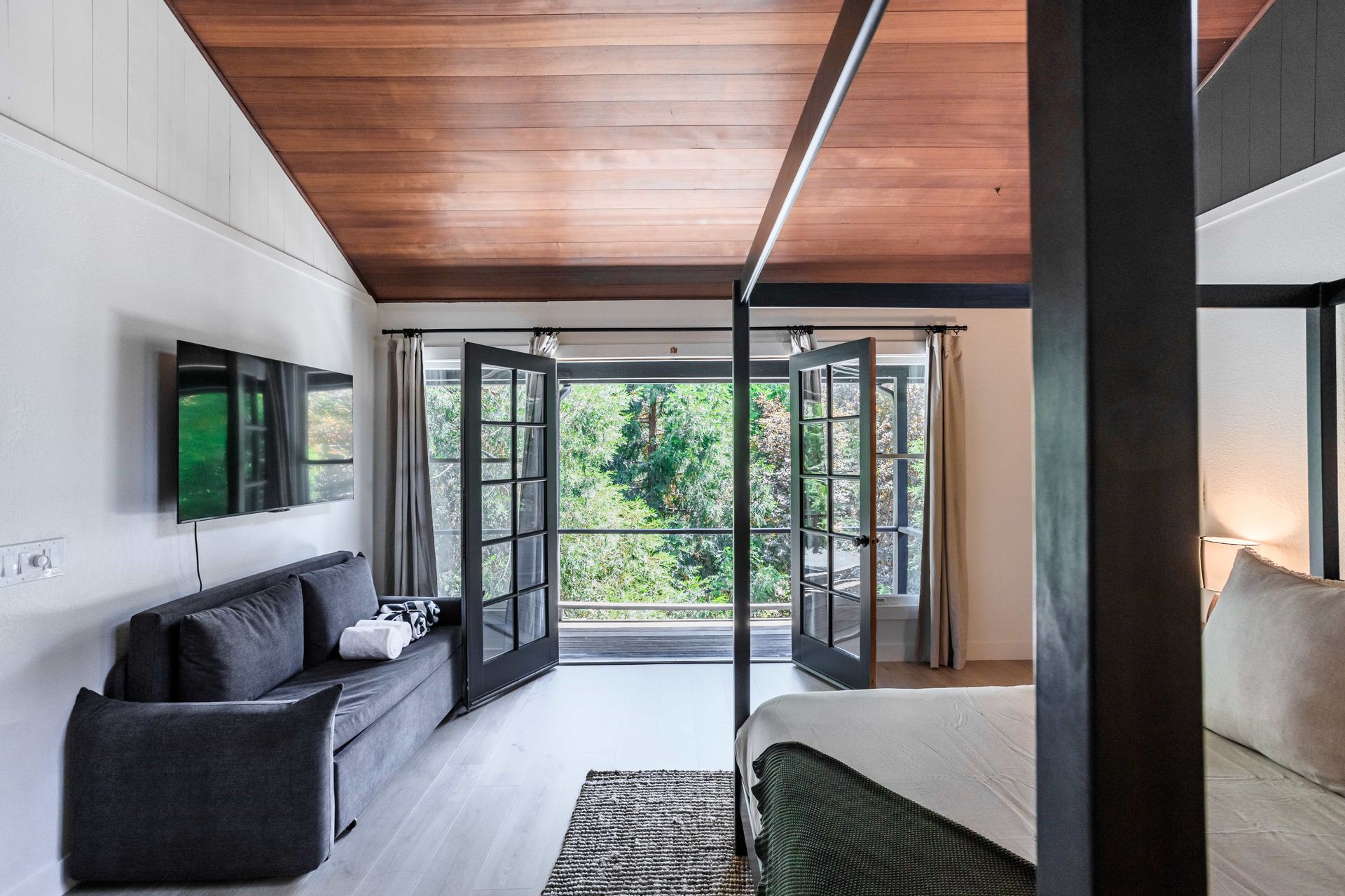 A bedroom with a canopy bed and a couch