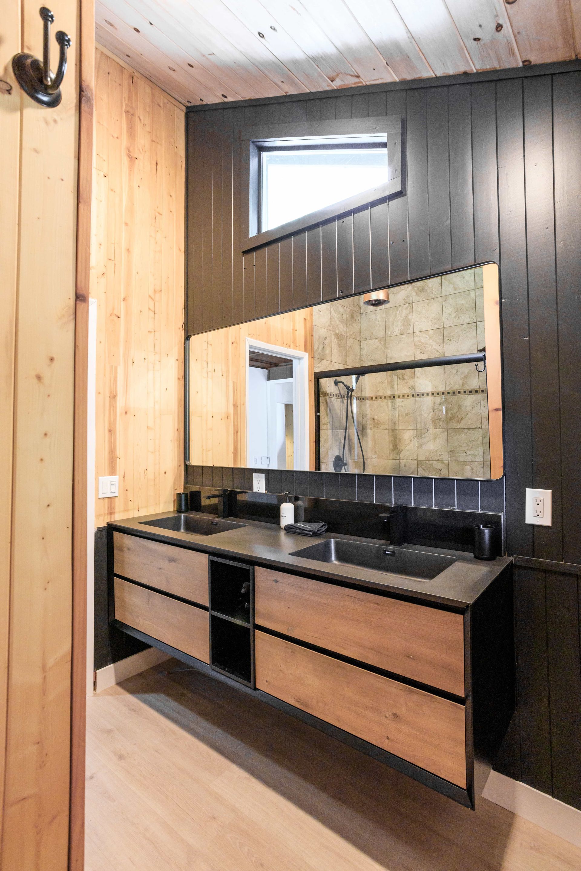 A bathroom with two sinks and a large mirror.