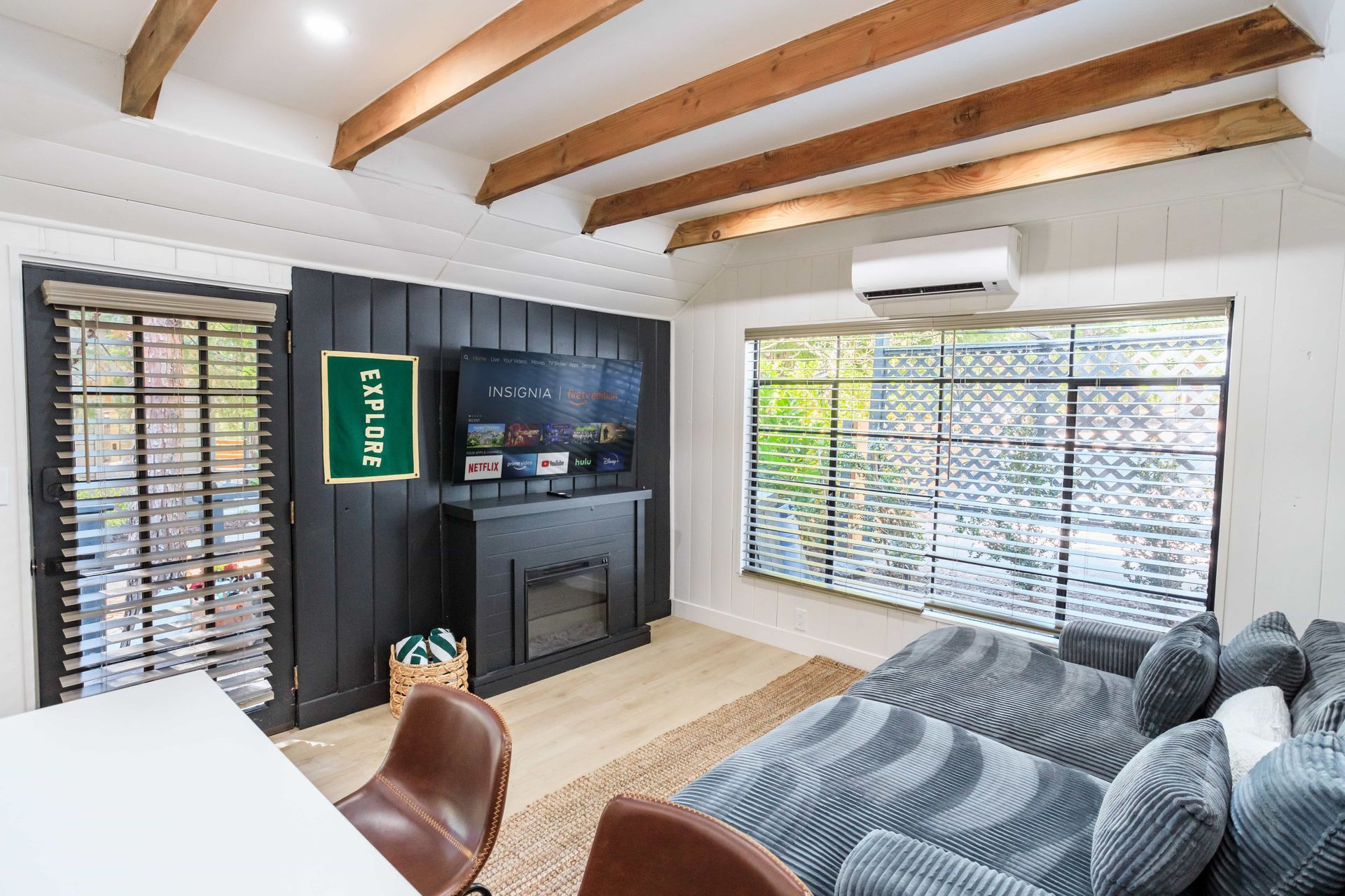 A living room with a fireplace and a flat screen tv