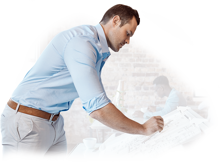 A man in a blue shirt is writing on a piece of paper.