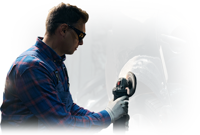 A man is working on a tire on a car.