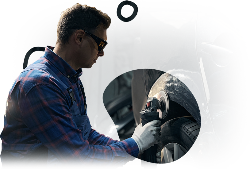 A man is working on a tire on a car.