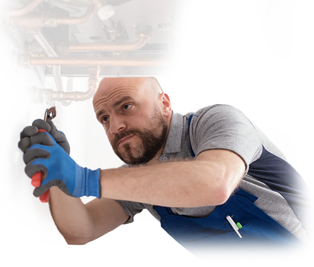 A man wearing blue gloves is working on a pipe
