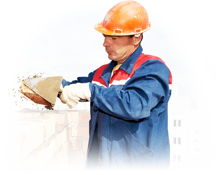 A man wearing a hard hat is working on a building