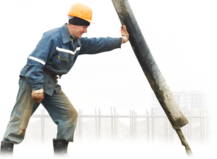 A man wearing a hard hat is holding a large pipe
