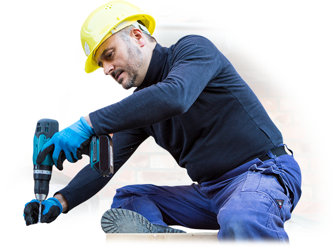 A man wearing a hard hat is working with a drill.