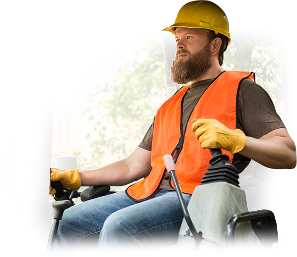 A man wearing a hard hat and an orange vest is driving a forklift.