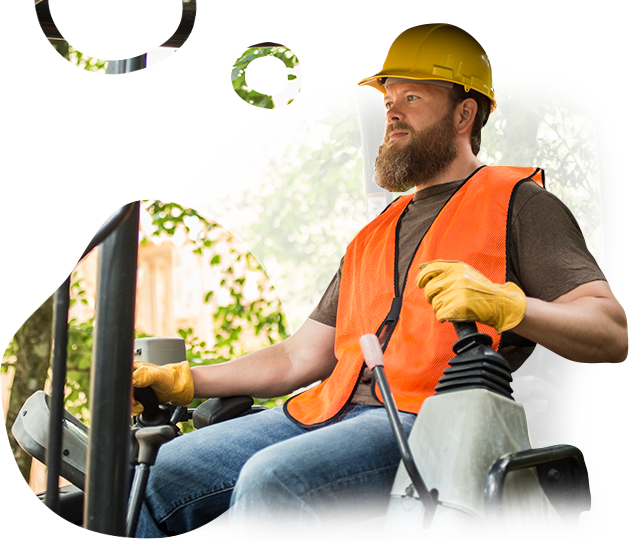 A man wearing a hard hat and an orange vest is driving a forklift.