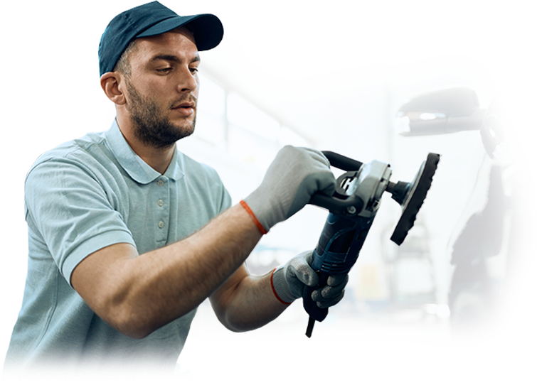 A man is polishing a car with a machine.