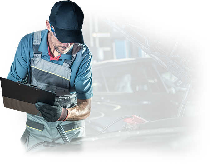 A man is looking at a clipboard in front of a car.