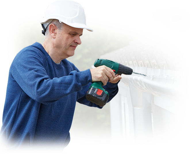 A man is fixing a gutter with a drill.