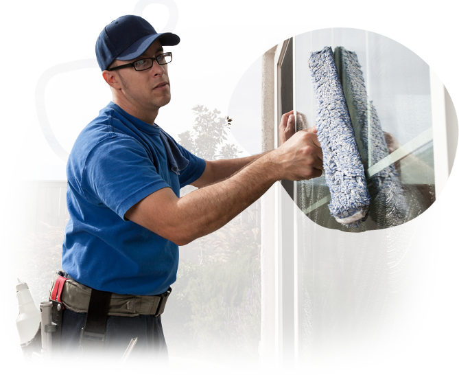 A man wearing blue gloves is cleaning a gutter on a roof.