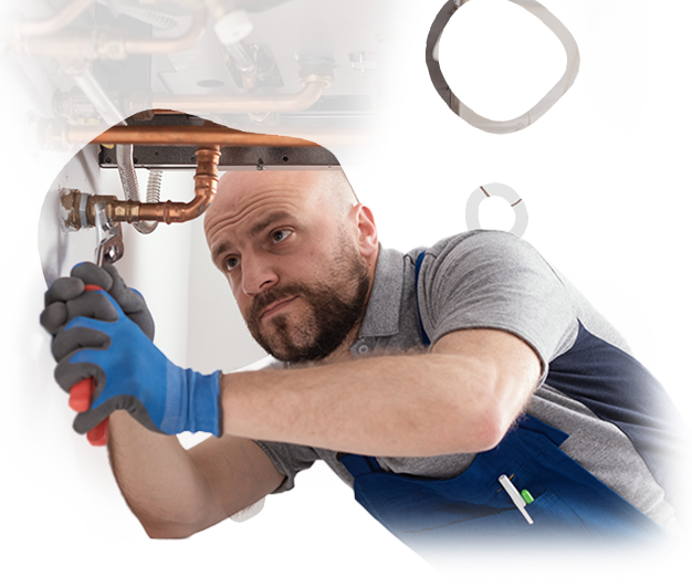 A man wearing blue gloves is working on a pipe