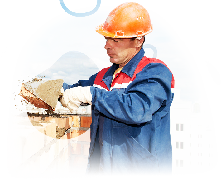 A man wearing a hard hat is working on a building