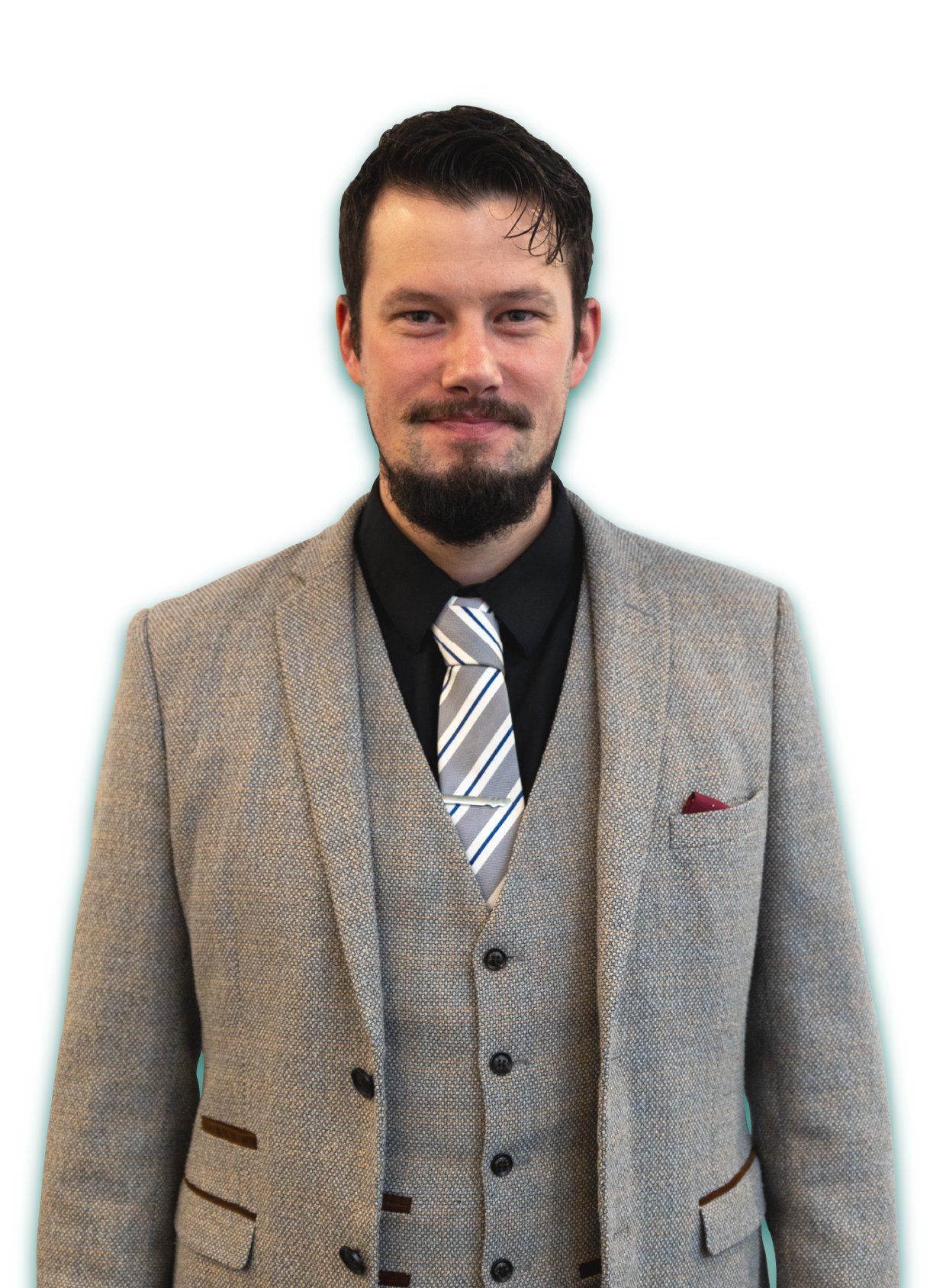 A man in a suit and tie is standing in front of a white background.