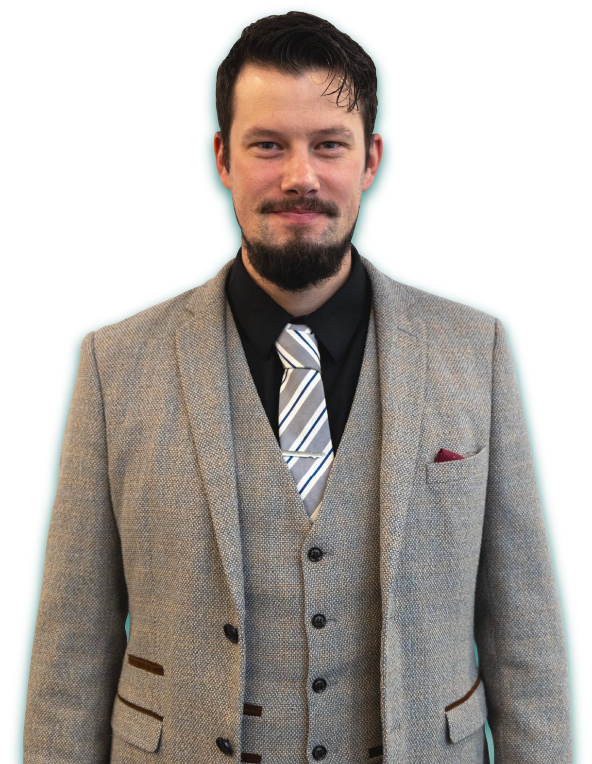 A man in a suit and tie is standing in front of a white background.