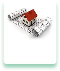 A model house is sitting on top of a roll of blueprints.