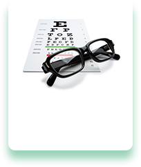 A pair of glasses sitting on top of an eye chart.