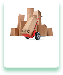 A hand truck is carrying a cardboard box in front of a pile of cardboard boxes.