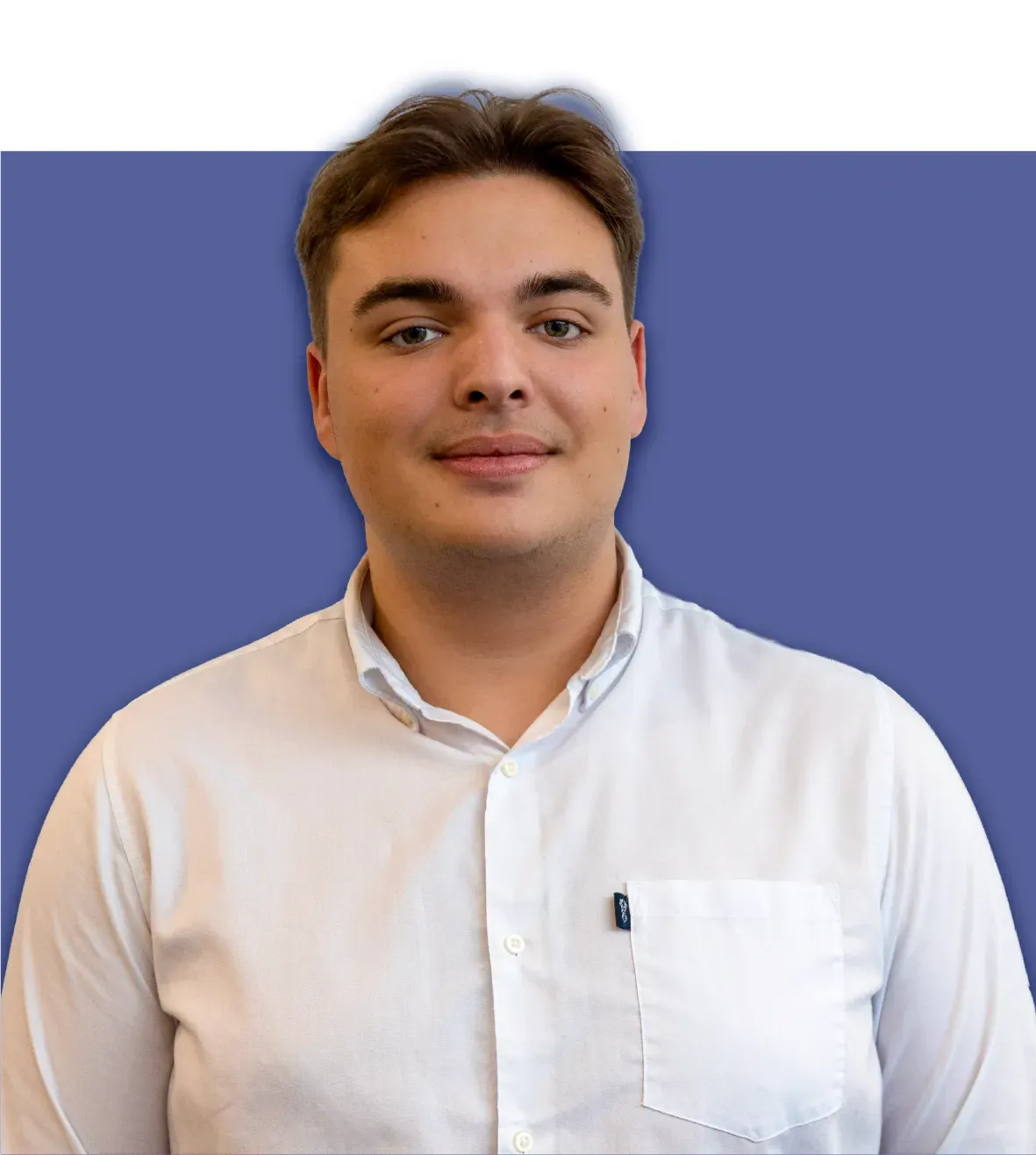 Man in white shirt against a blue background, looking forward.