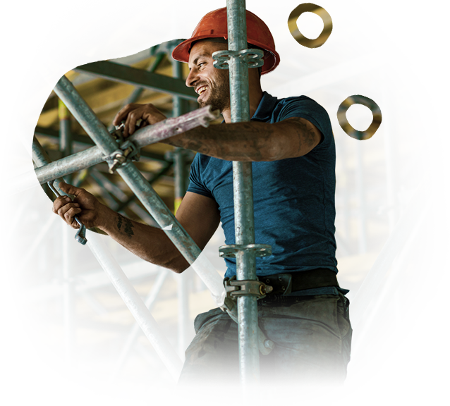 A man wearing a hard hat is working on a scaffolding