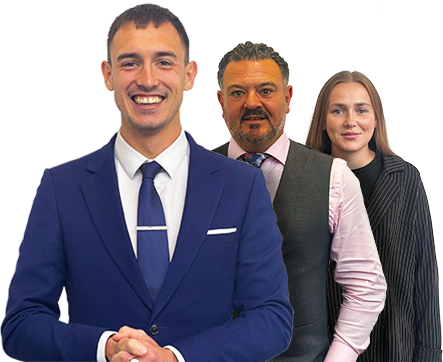 A man in a blue suit and tie is standing next to two other people