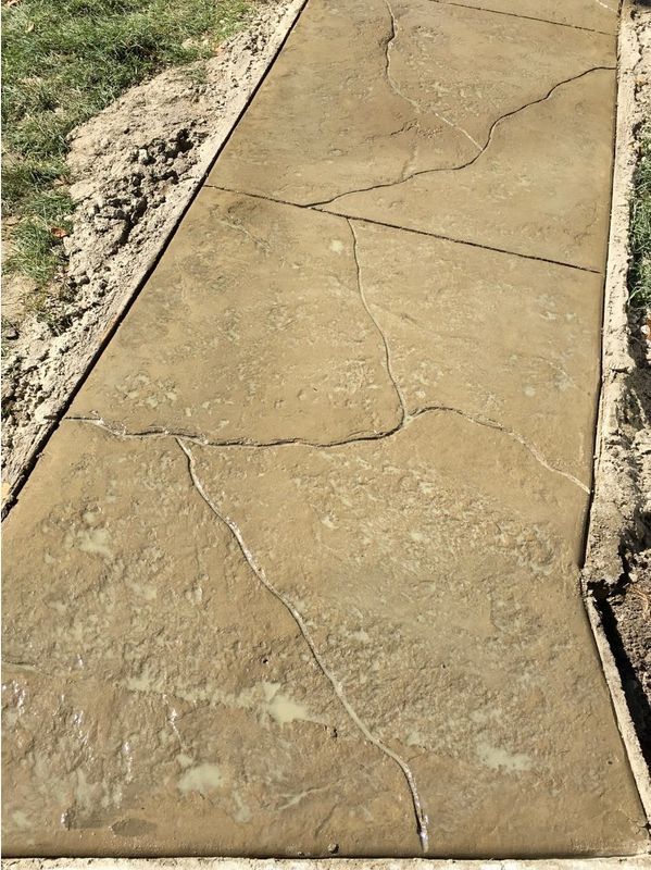 Closeup of a freshly poured stamped concrete walkway.