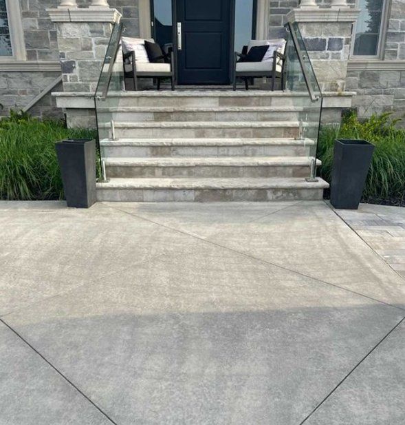 Stamped concrete patio with concrete steps leading up to the front entrance of a house in Oshawa.