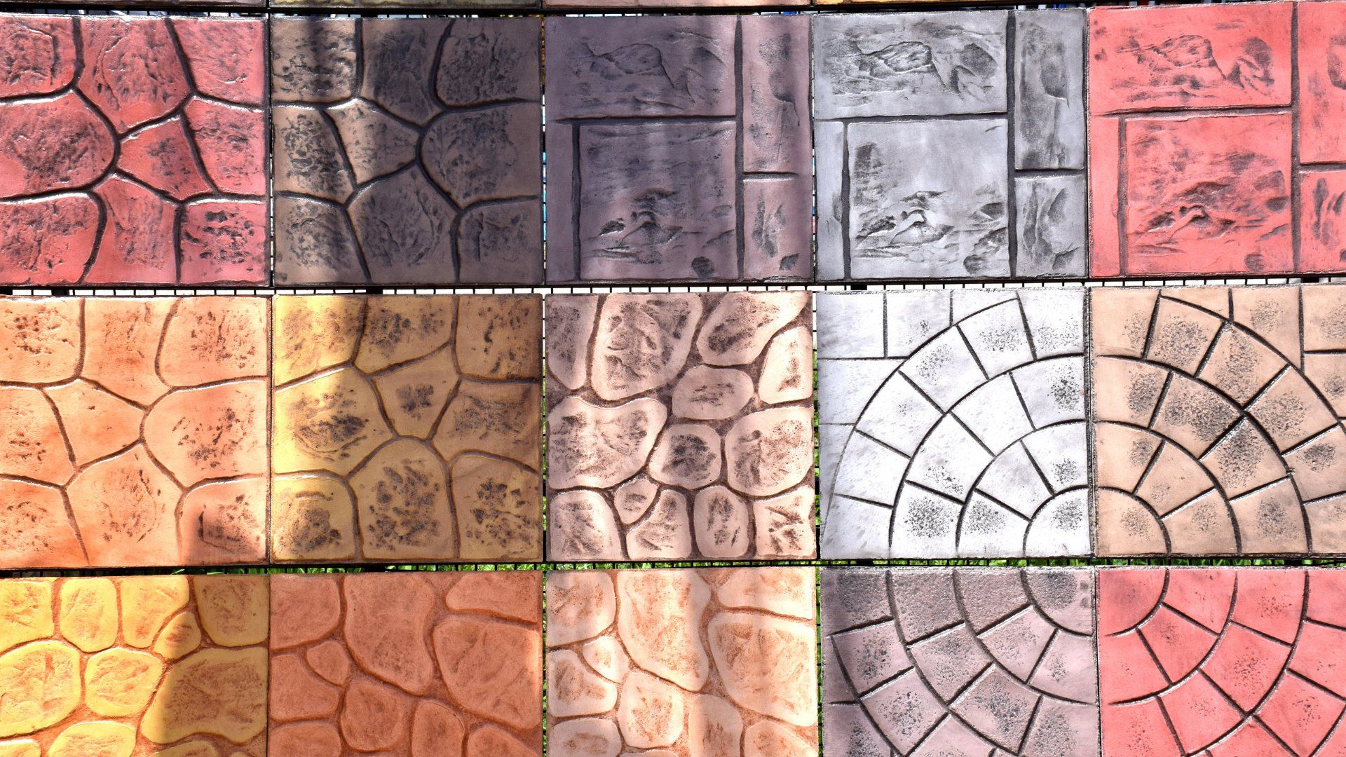 Closeup picture of a variety of stamped concrete colours , designs, and textures.