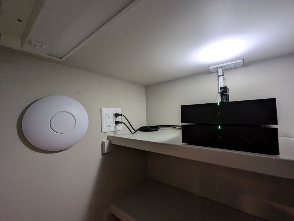 A shelf with a router and a light on it