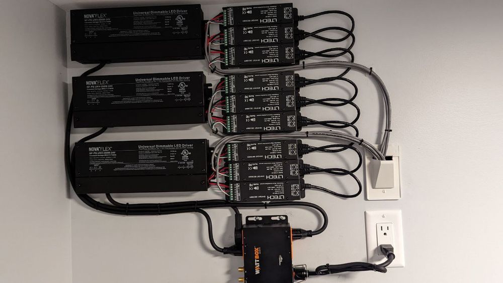 A bunch of wires are connected to a wall.