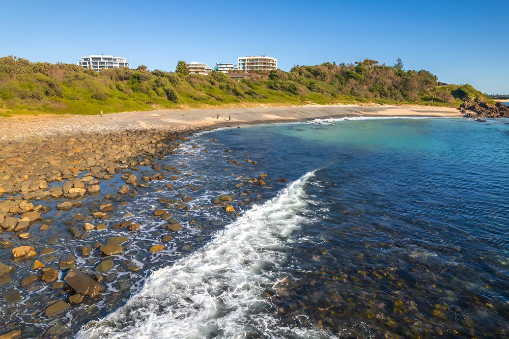 An aerial view of a rocky beach next to a body of water.