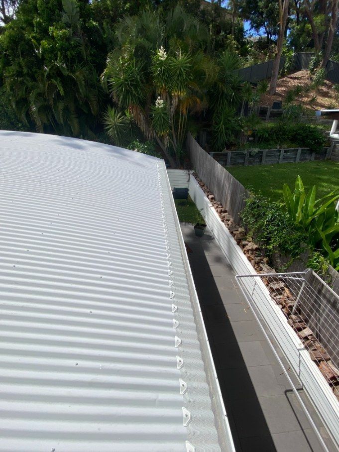 A White Roof With A Gutter On The Side Of It — The Guttering Cleaning Man in Taree, NSW