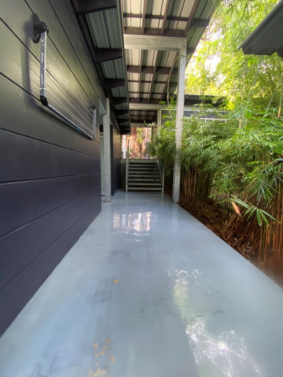 A Concrete Walkway Leading To A House With Stairs — The Guttering Cleaning Man in Forster, NSW