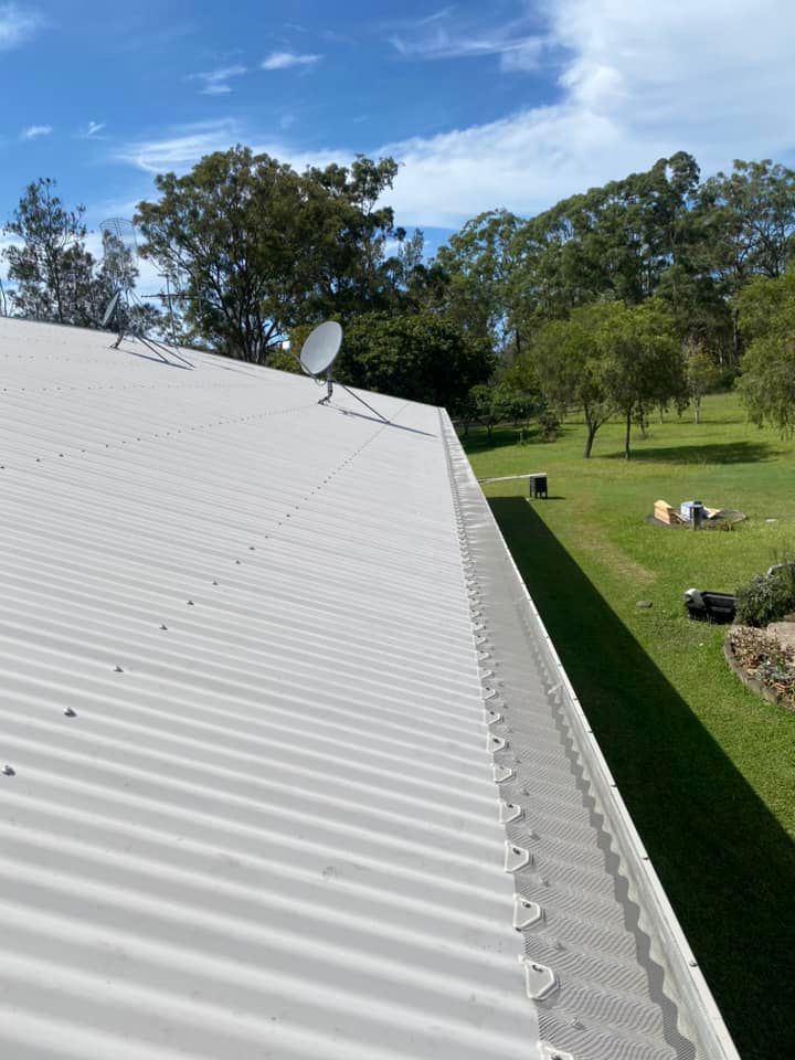A White Roof With A Satellite Dish On Top Of It — The Guttering Cleaning Man in Forster, NSW