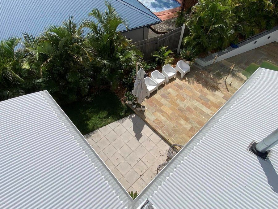 An Aerial View Of A Patio With Chairs And Umbrellas — The Guttering Cleaning Man in Taree, NSW