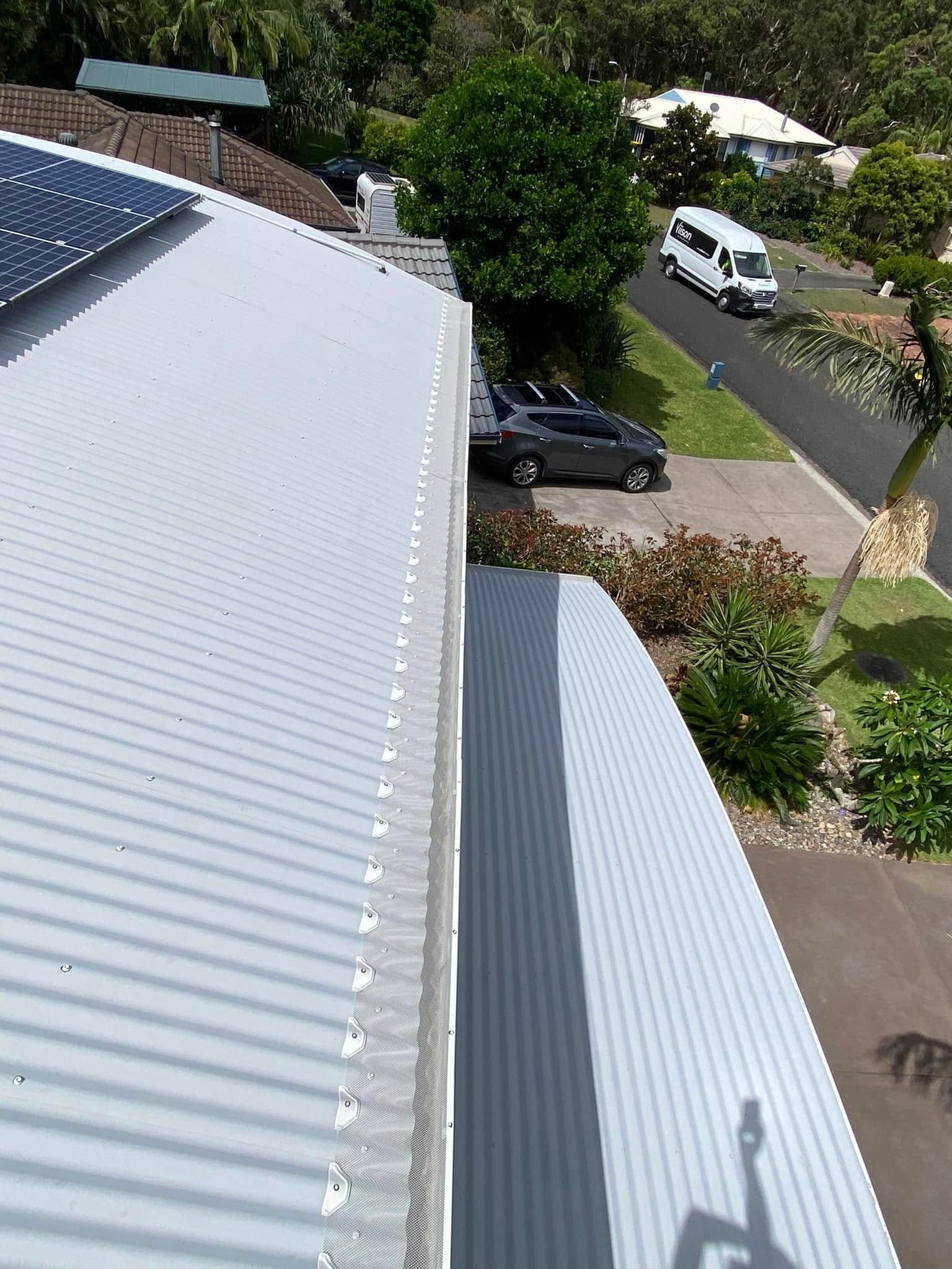 A Roof With A Lot Of Leaves On It — The Guttering Cleaning Man in Old Bar, NSW