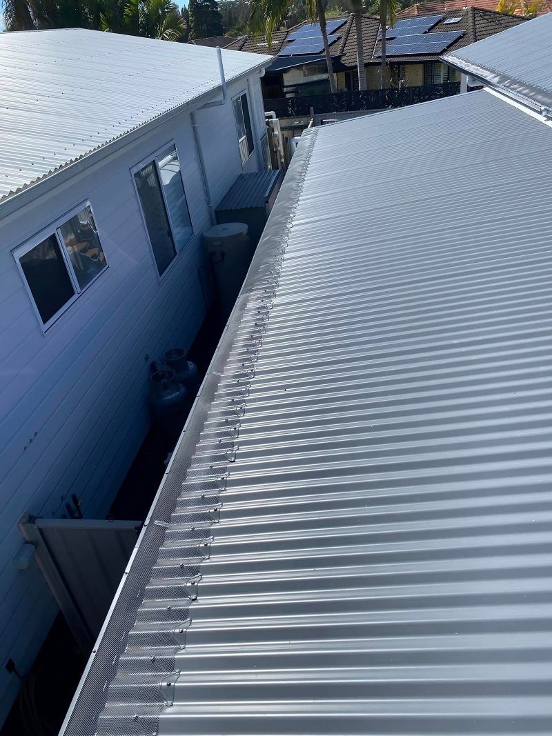 An Aerial View Of A White House With A Metal Roof — The Guttering Cleaning Man in Taree, NSW