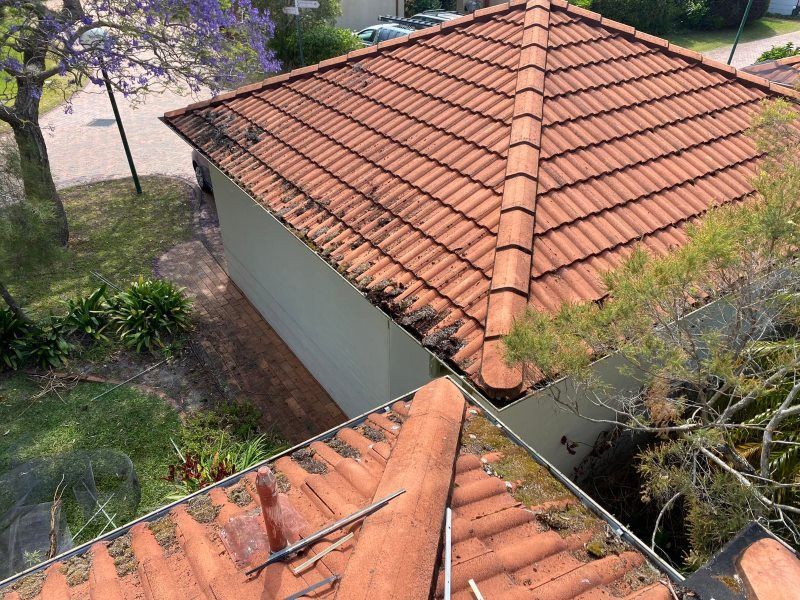An Aerial View Of A Tiled Roof Of A House — The Guttering Cleaning Man in Wingham, NSW