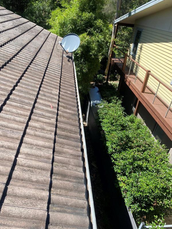 A Roof With A Satellite Dish On Top Of It — The Guttering Cleaning Man in Harrington, NSW