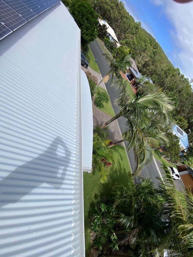 An Aerial View Of A House With Solar Panels On The Roof — The Guttering Cleaning Man in Tuncurry, NSW