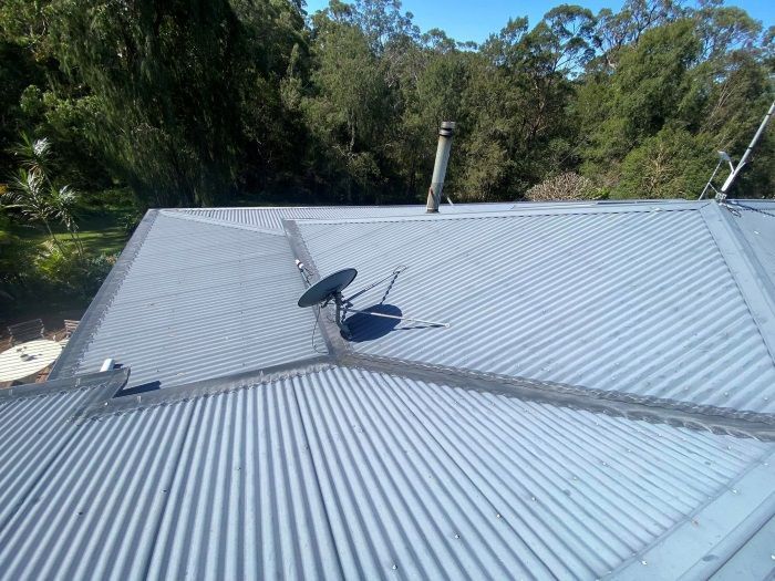 A Satellite Dish Is Sitting On The Roof Of A House — The Guttering Cleaning Man in Tuncurry, NSW